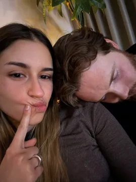 Mariana shushing while Joris rests his head on her