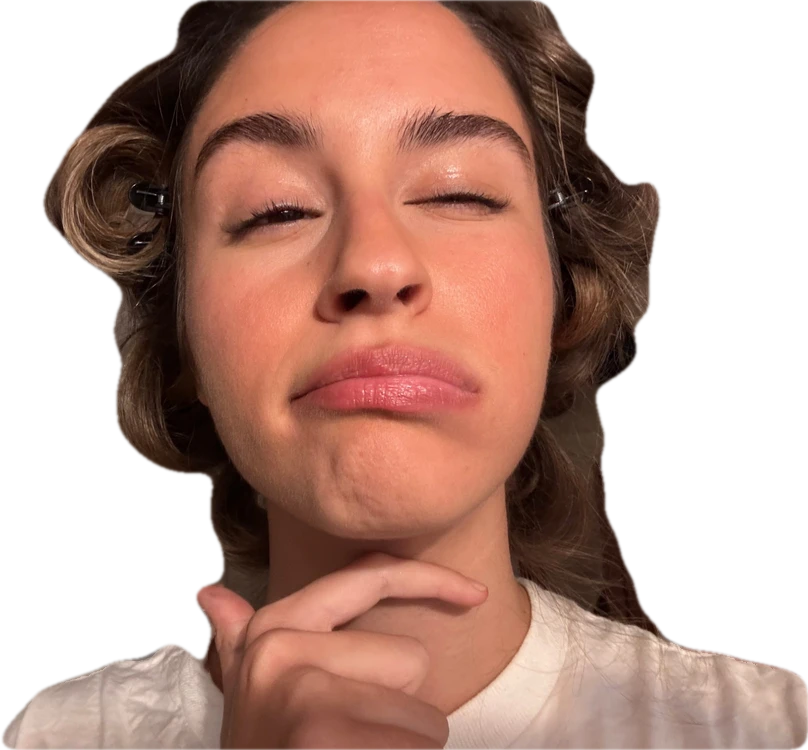 Mariana in hair rollers, pulling a face